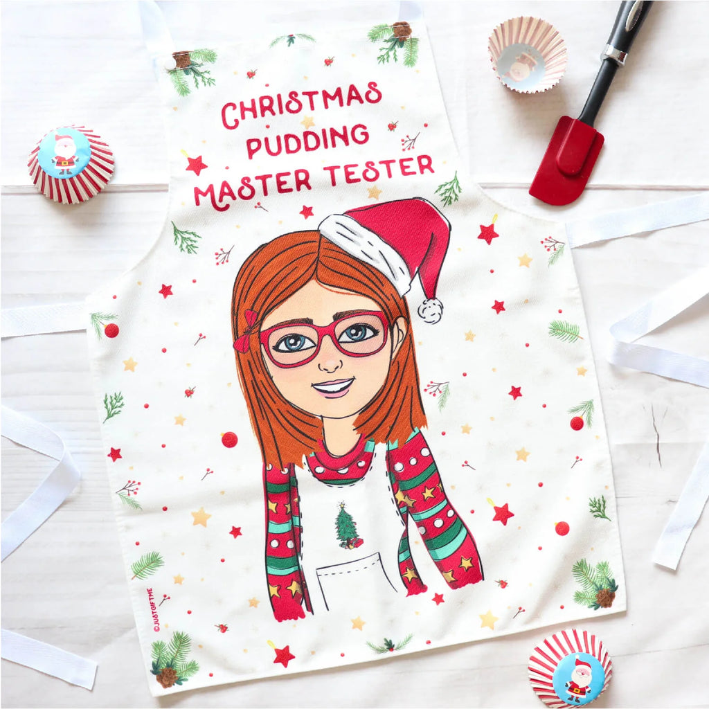 Personalised Christmas apron for girls with customised cartoon in pine cone pattern. At the top it says Christmas Pudding Master Tester