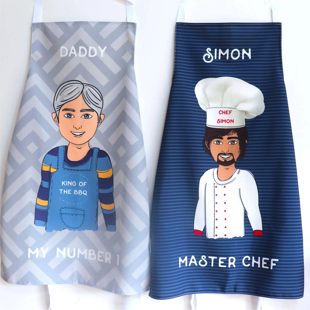 Personalised aprons one grey and one blue showing two customisable cartoon themes available (chef and BBQ) and customised text