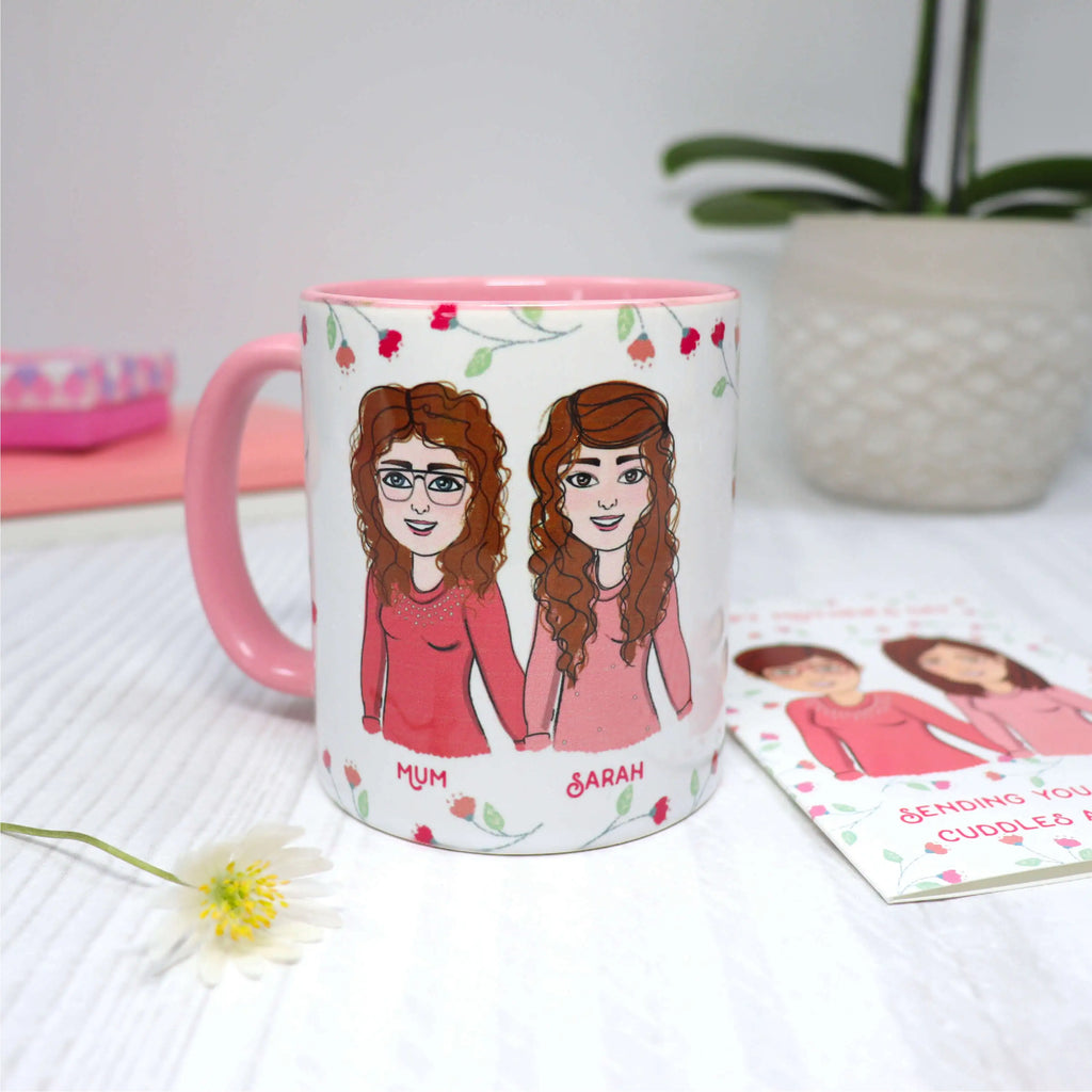 Personalised mum mug with customised mother and daughter cartoon and pink floral background next to personalised  mothers day card with same design